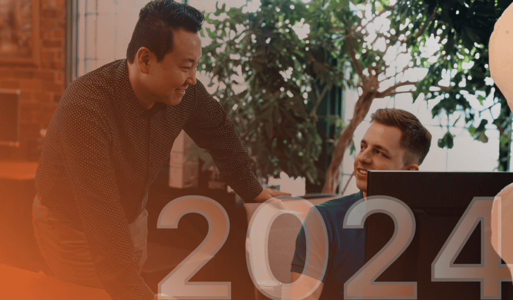 Two men in front of a computer screen, discussing how to refresh their IT systems