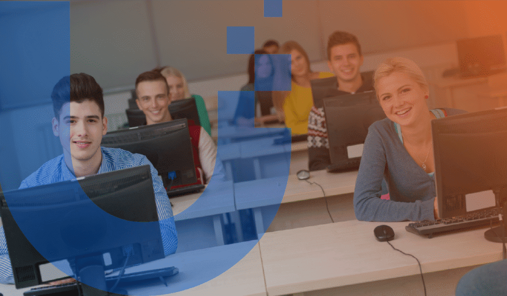 An image representing IT procurement in education and school settings. There is a photo of a group of older teenagers in a classroom, smiling at the camera, as they all sit at their computers.