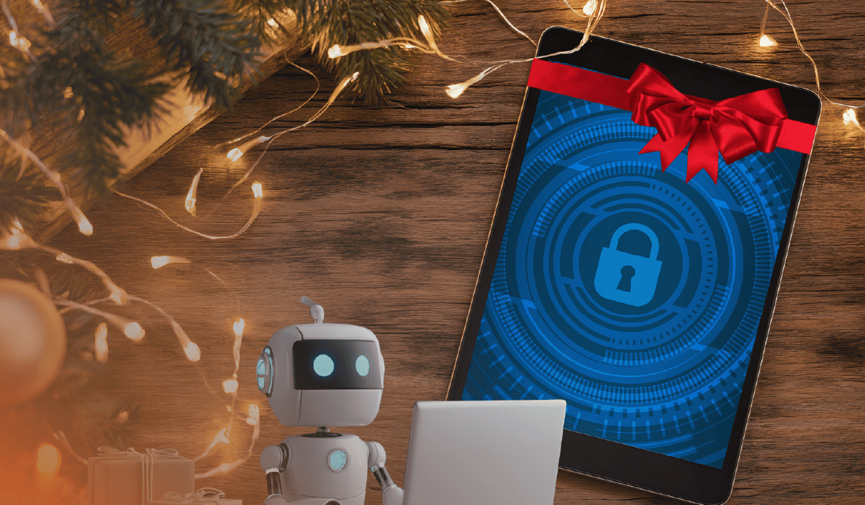 An image that represents to the title "‘Tis the Season to Secure Your New Devices. Here’s How." Laid out on a wooden table is Christmas lights, a fir tree, a laptop with a lock image on display tied with a red bow.