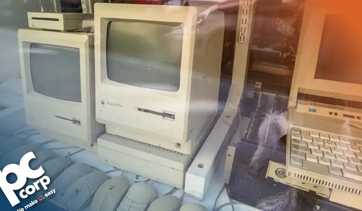 An image representing the blog's title: What Are the Risks of Running Outdated IT Infrastructure? There is a photo of old-school 90s style computers.